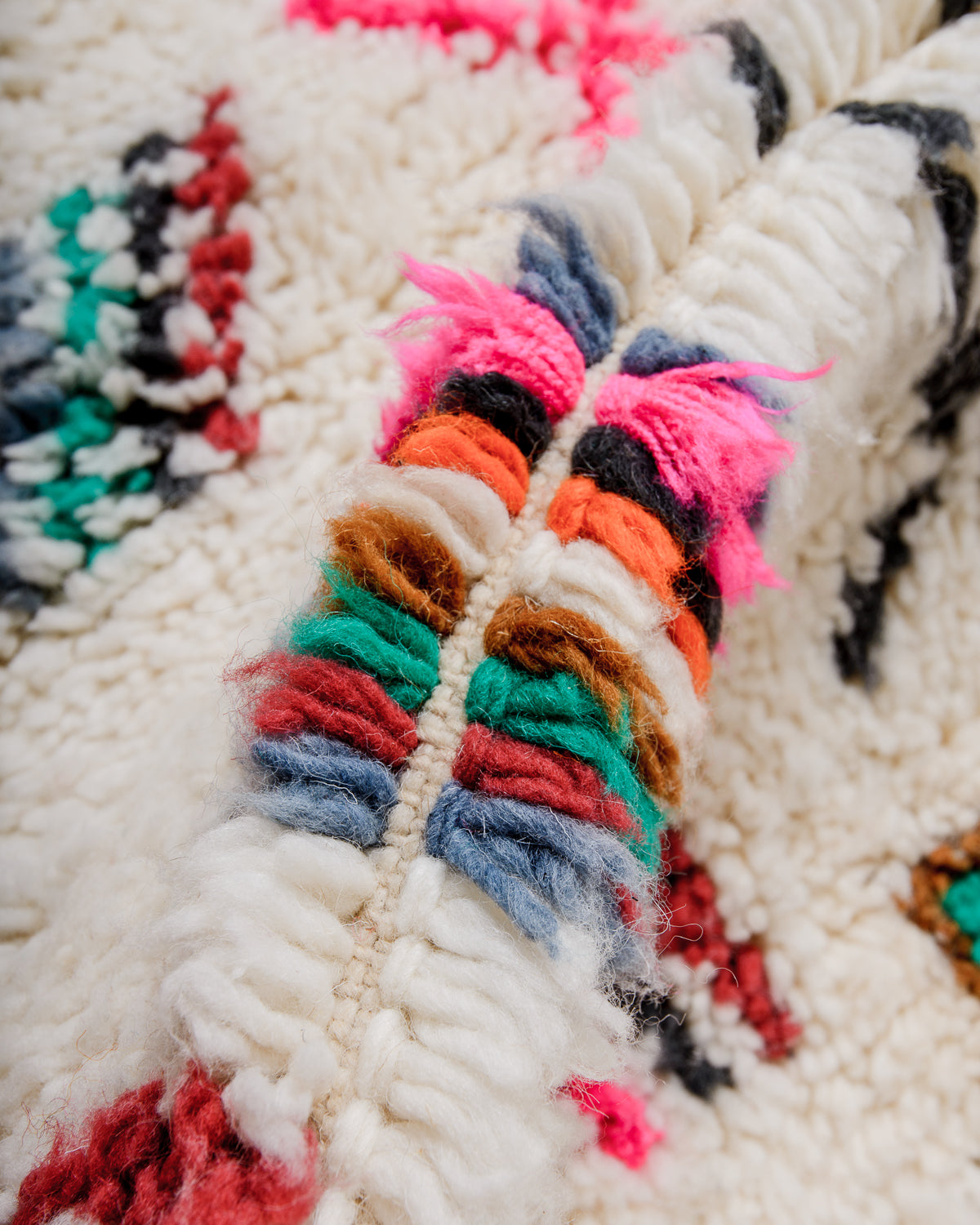 Detail of wool berber rug showing depth of pile and different coloured wool used.